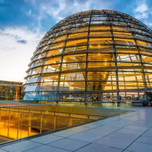 Illuminated Reichstag building, glass dome modern monument with spiral walkways to the top