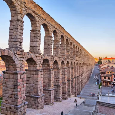 Roman aqueduct of Segovia under a sunset sky