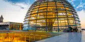 Illuminated Reichstag building, glass dome modern monument with spiral walkways to the top