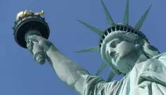 Close-up of the Statue of Liberty against a blue sky in New York